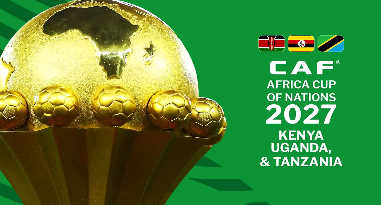 كأس أمم إفريقيا الذهبية بجانب شعار CAF لنسخة 2027 التي تستضيفها كينيا وأوغندا وتنزانيا، مخصصة لاستعراض مواعيد الافتتاح والنهائي